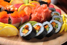Sushi auf einem Teller, bunt mit orangefarbenem Lachsfisch