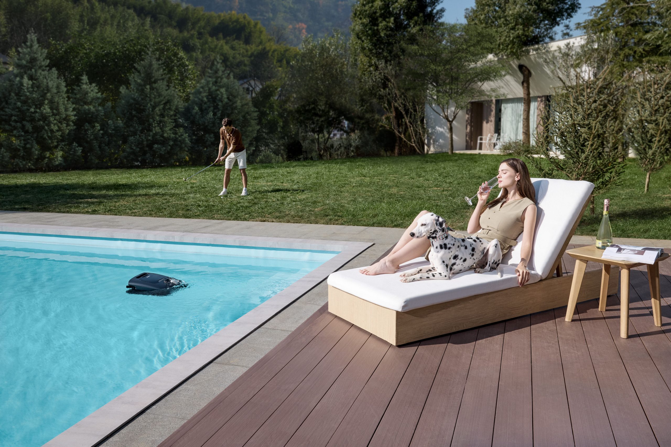 Beatbot AquaSense 2 Ultra owners relaxing while the robotic pool cleaner clears the pool.