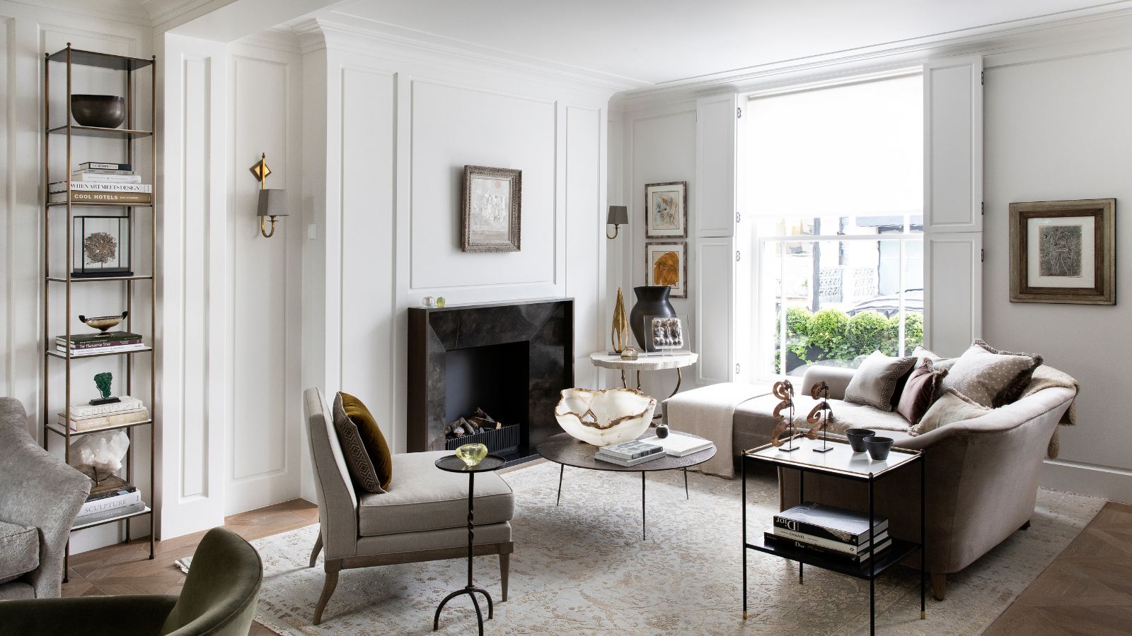 Bright white living room with grey furniture, and a black-surround fireplace