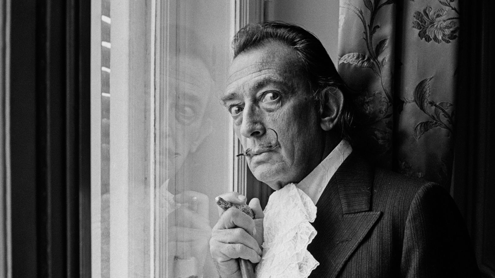 Salvador Dali in black and white against a window