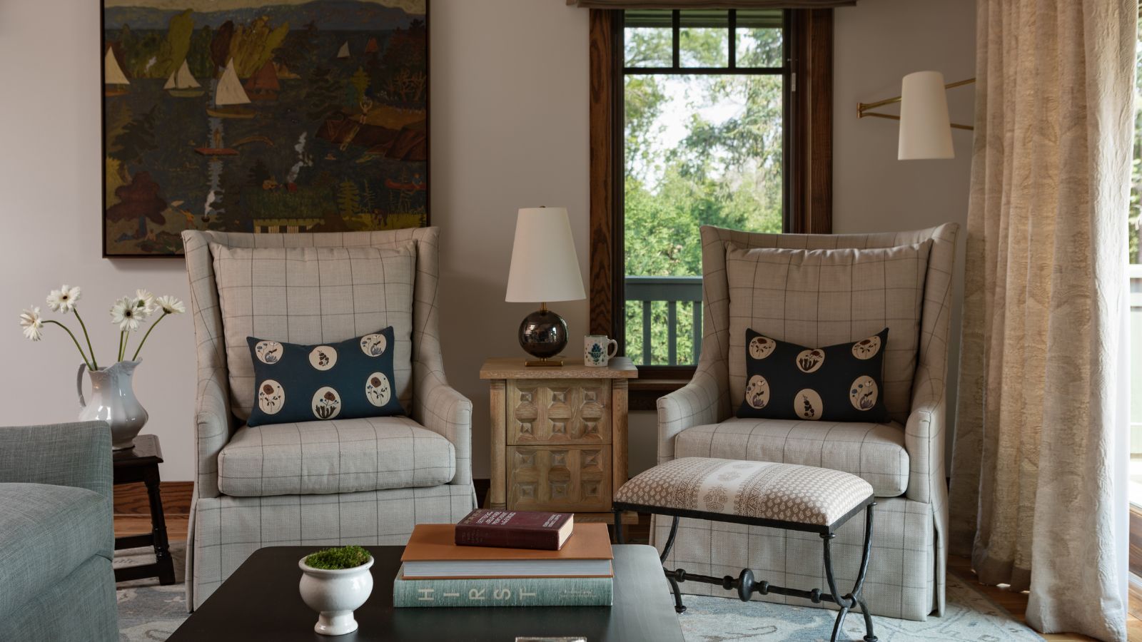 cozy living room in an arts and crafts home by oho interiors with wooden window frames, large abstract mid century, two plaid armchairs, and vintage decor