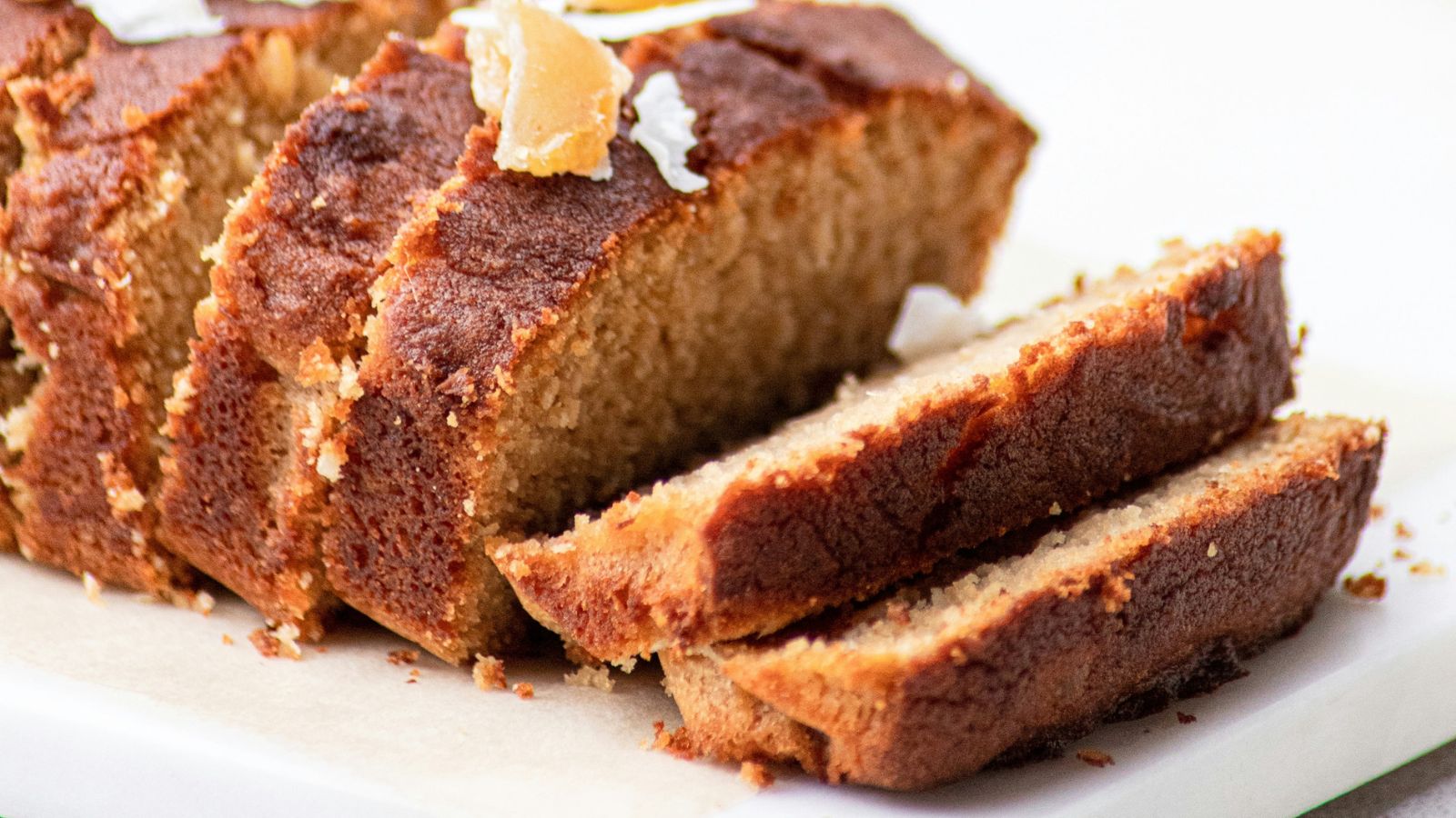 Sliced loaf of pumpkin cake with dried ginger on top
