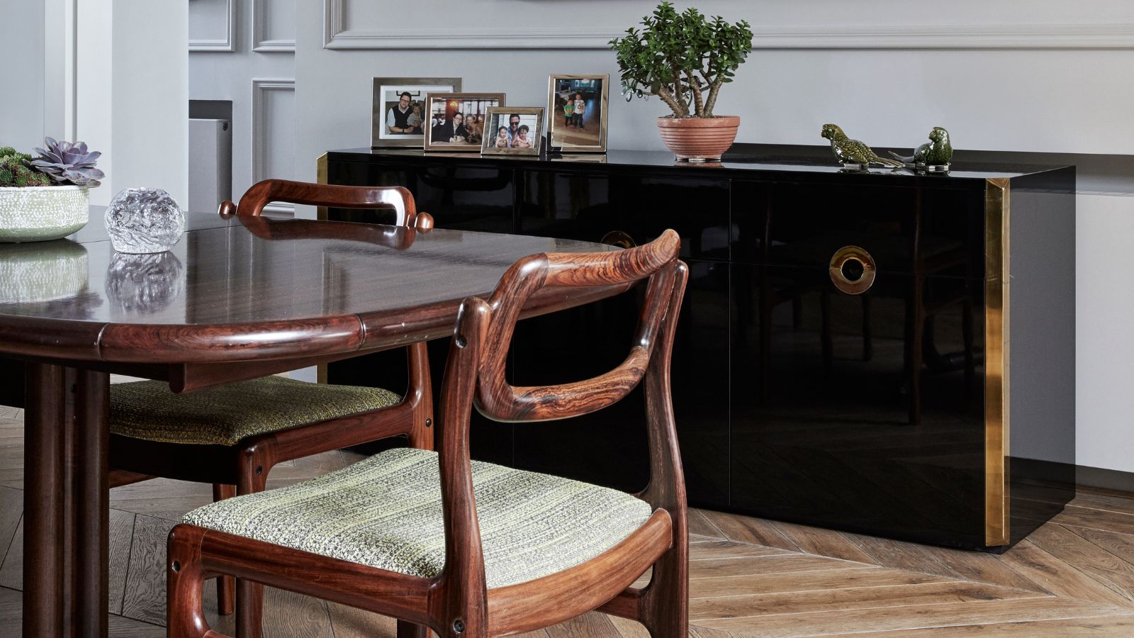 Dining room with mahogany furniture and a black polished dresser