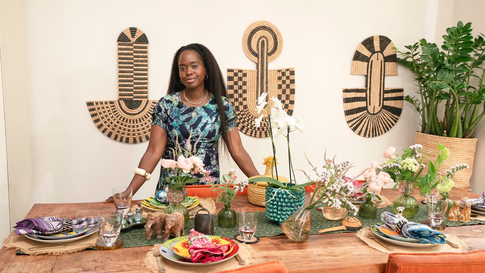 Eva Sonaike in her home by a table set up for a dinner party