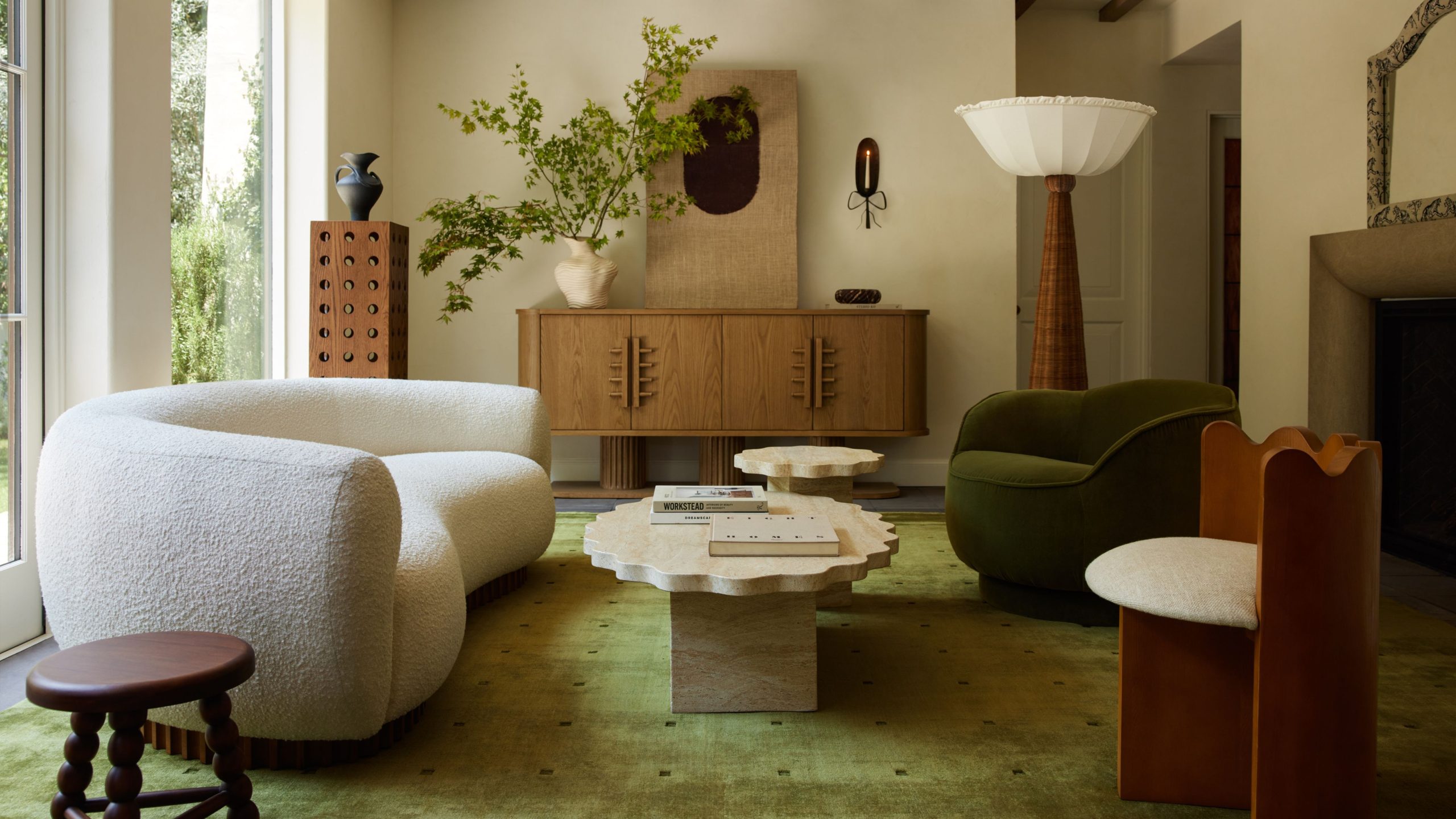 Lulu and Georgia x Sarah Sherman Samuel fall 2025 collection, including a green viscose area rug, playfully sculptured furniture, and woven lighting accents, pictured in a sunlit living room.