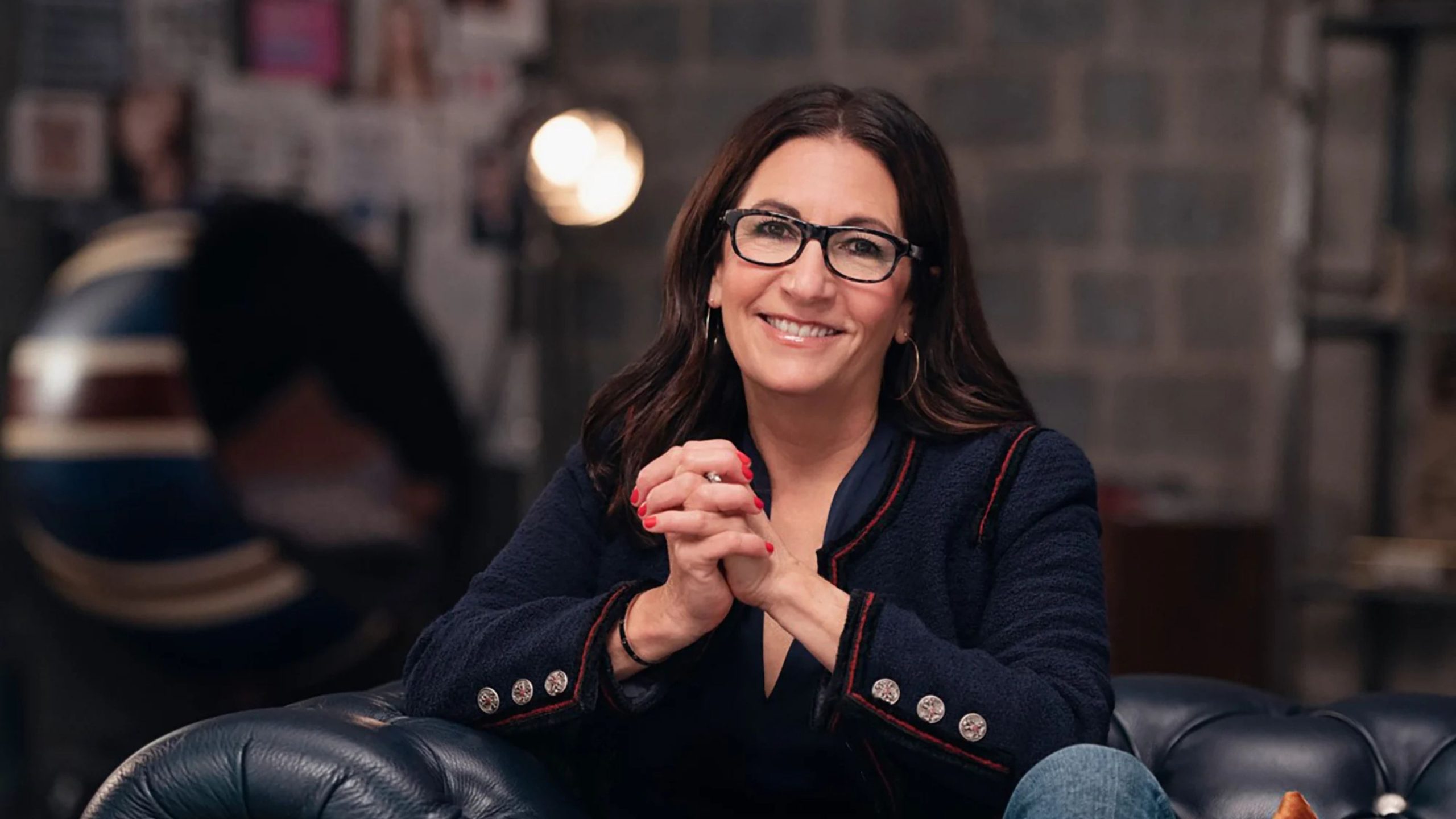 Portrait shot of Bobbi Brown on a leather sofa
