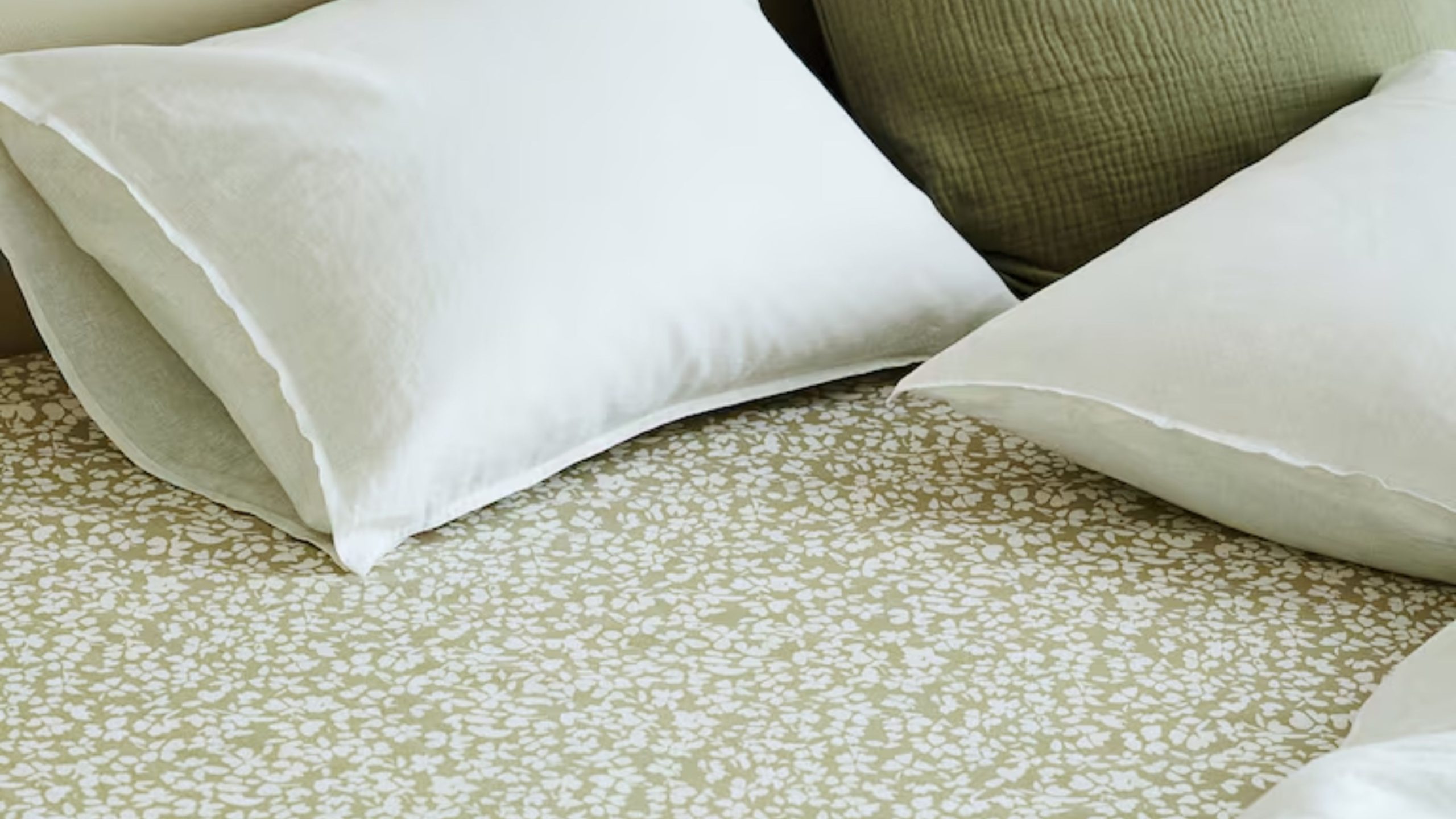 H&amp;M Home botanical patterned fitted sheet in sage styled with white and coordinating sage pillows