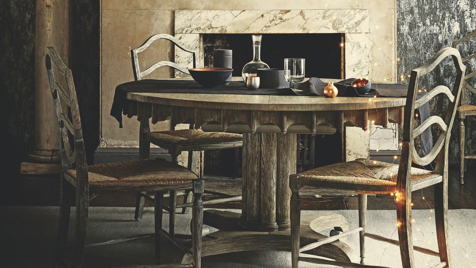 Rustic dining room with string lights and black ceramics