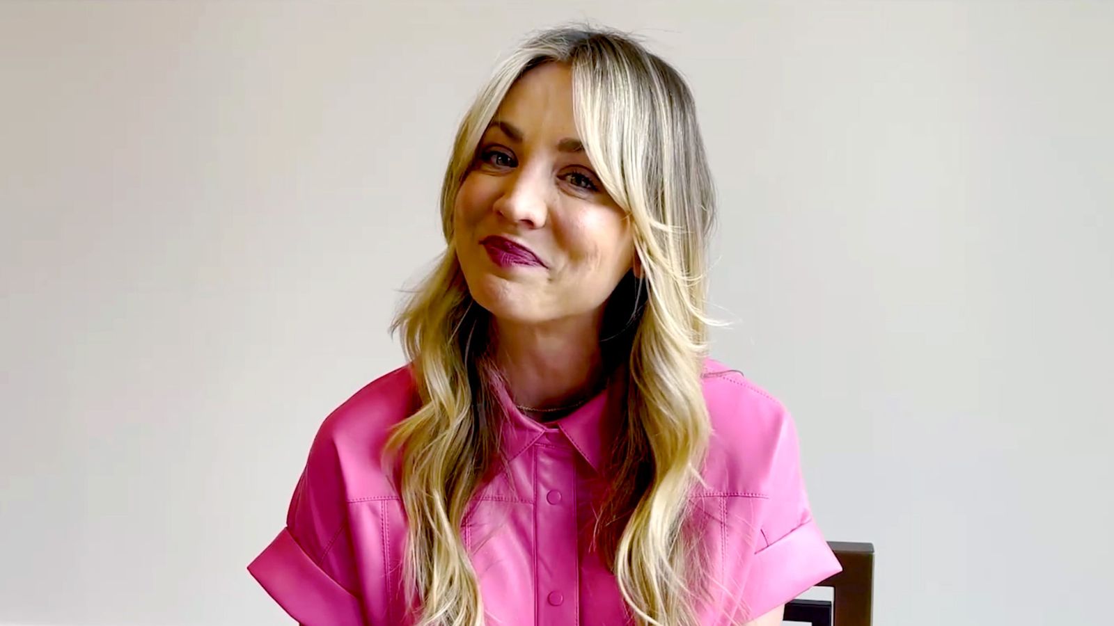 kaley cuoco on a white background wearing pink