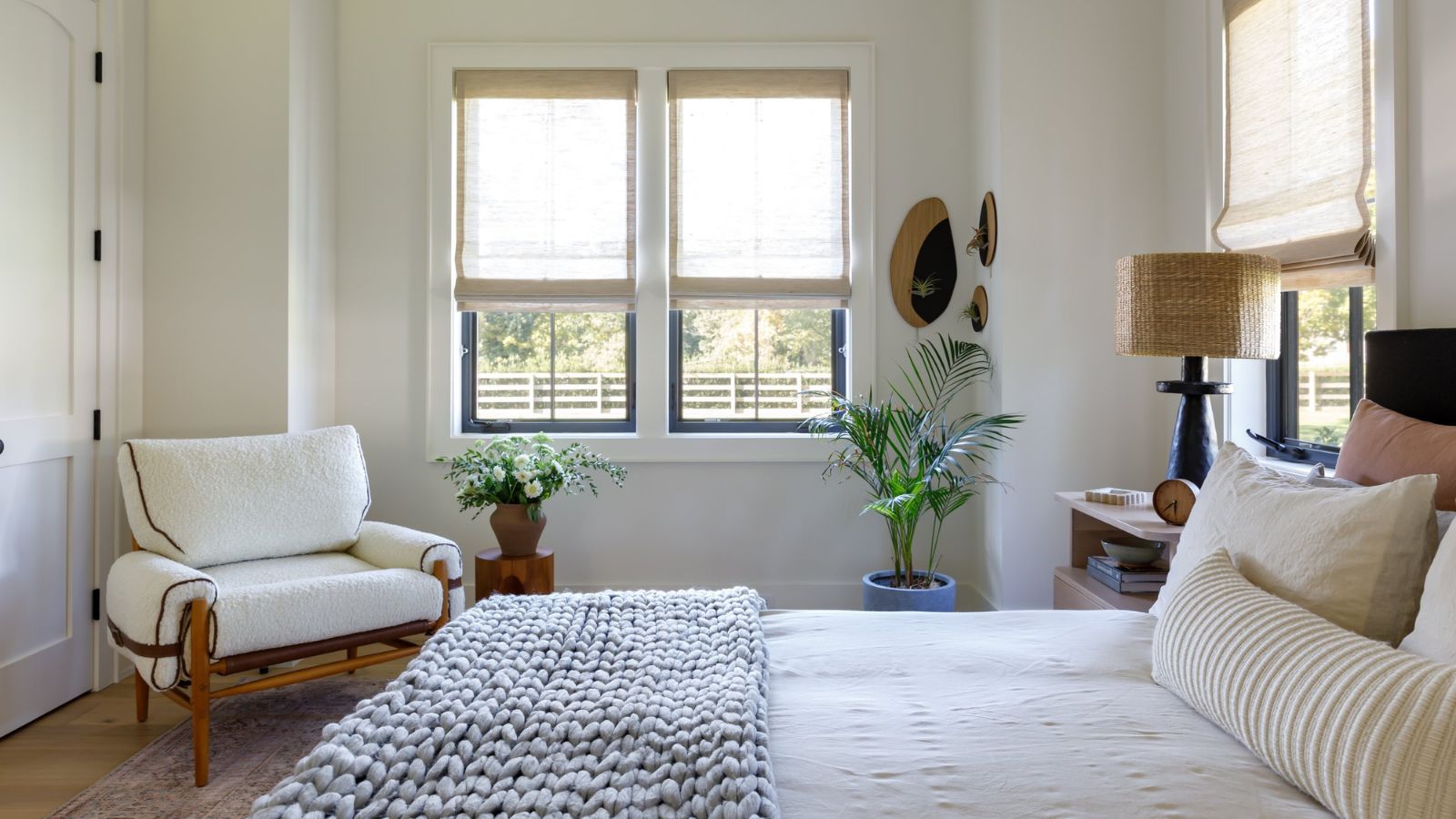 Small neutral bedroom with built in closets and armchair