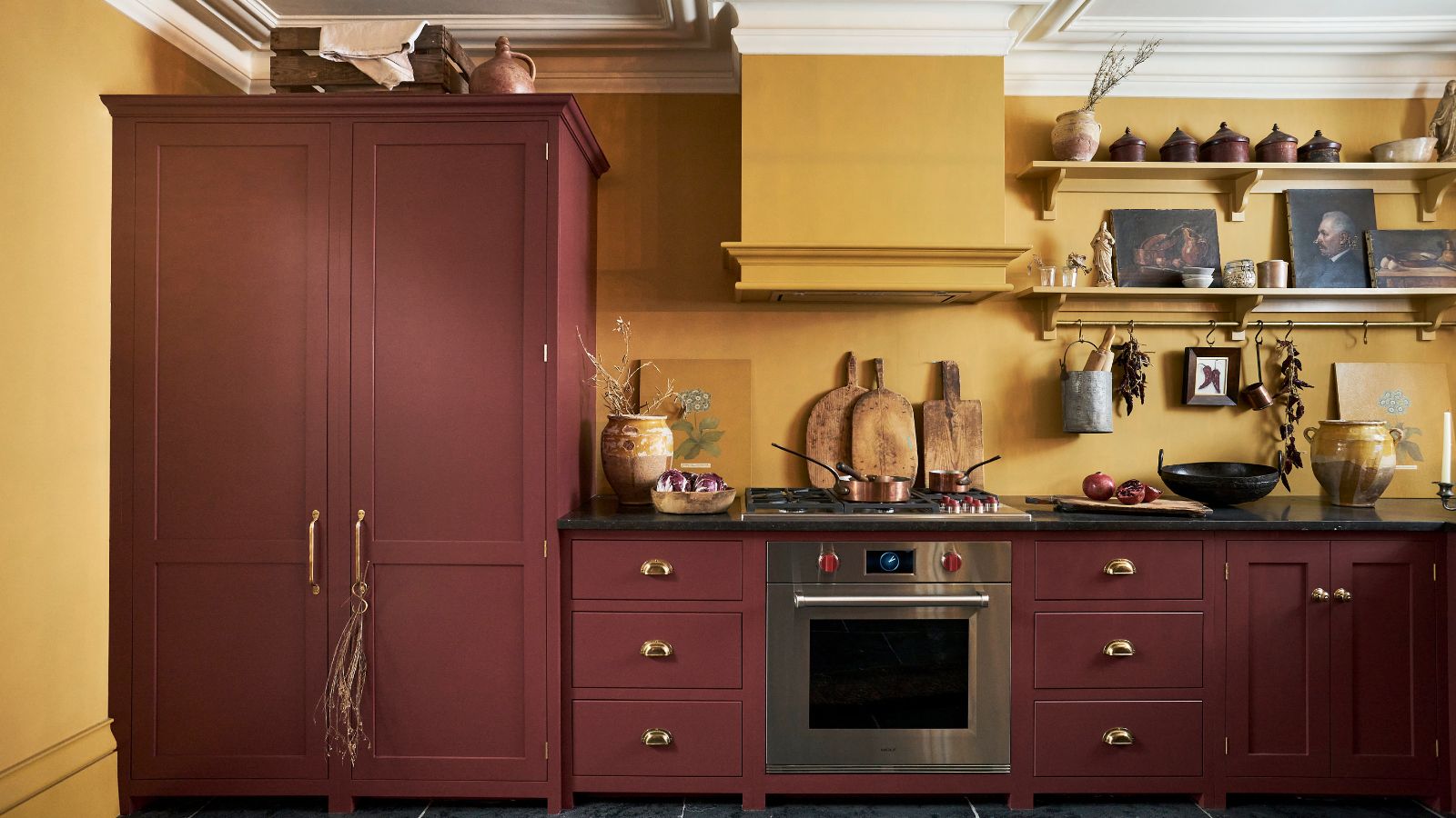 Burgundy shaker cabinets with mustard yellow walls in kitchen.