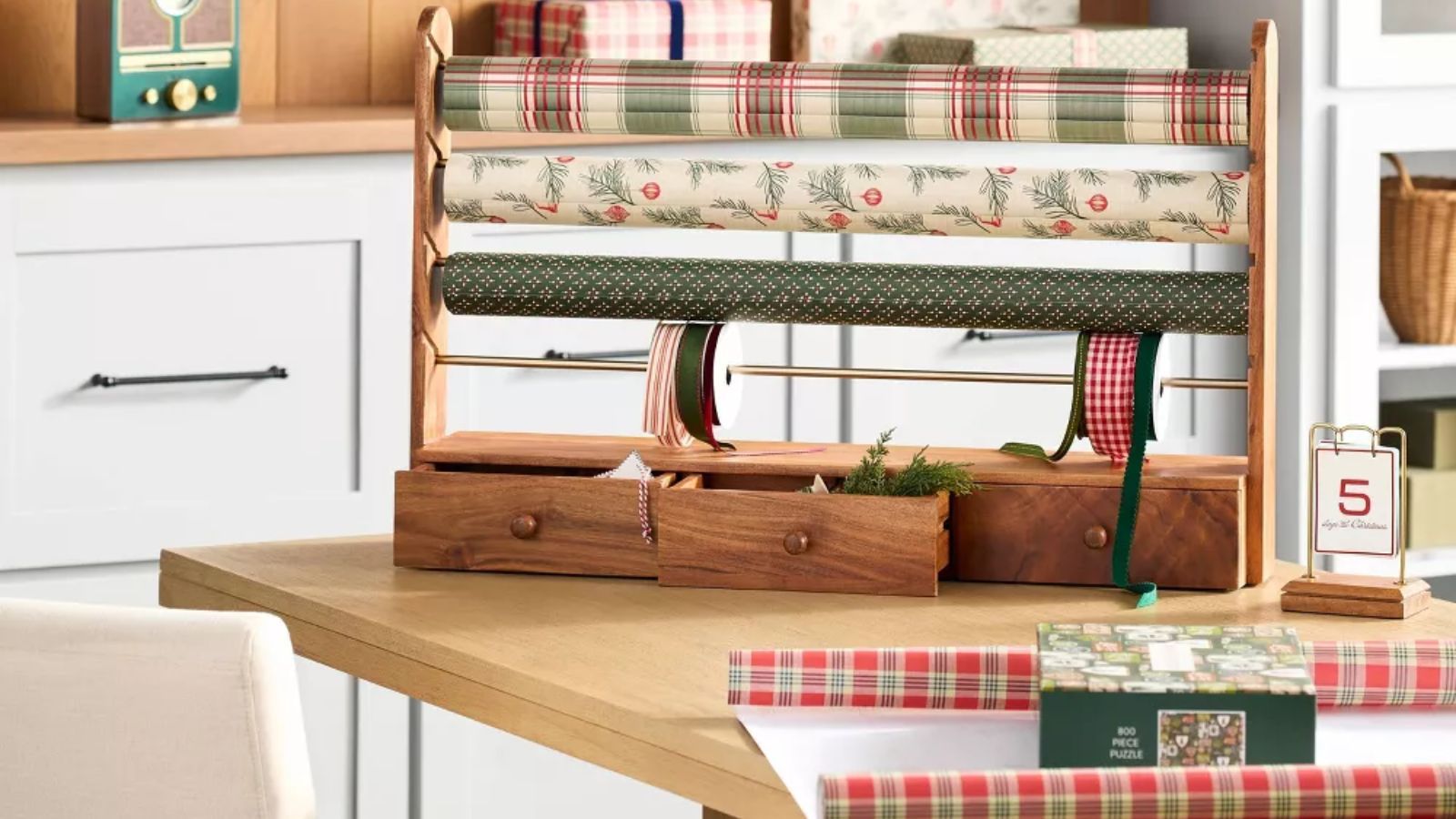 Wood and brass gift wrap holder with red and green plaid gift wrap