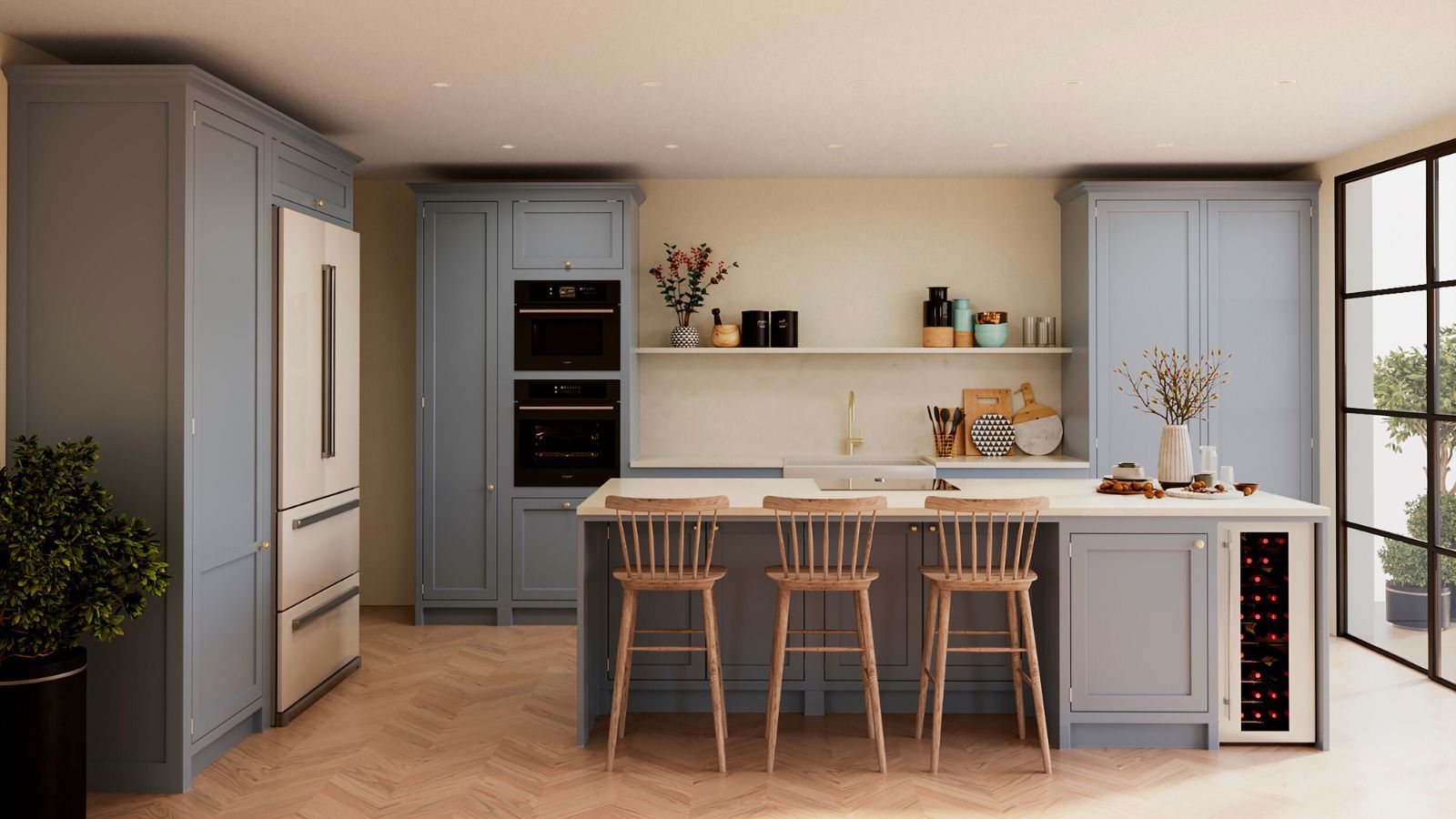 A blue kitchen with floor-to-ceiling cabinets, a matching island with three wooden barstools tucked beneath it. To the left, a tall stainless steel double-door fridge is built into units.