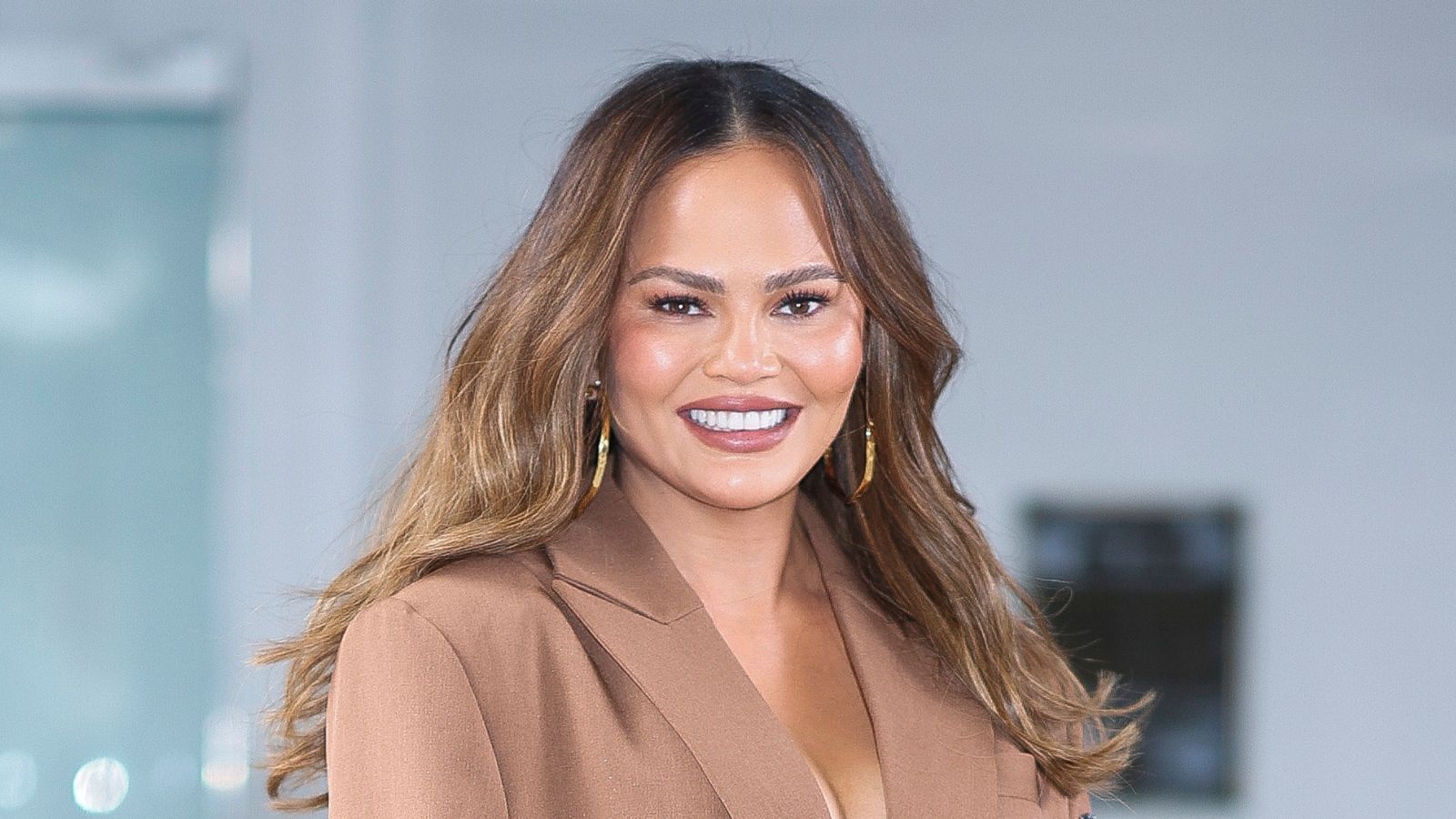 chrissy teigen on a blue background