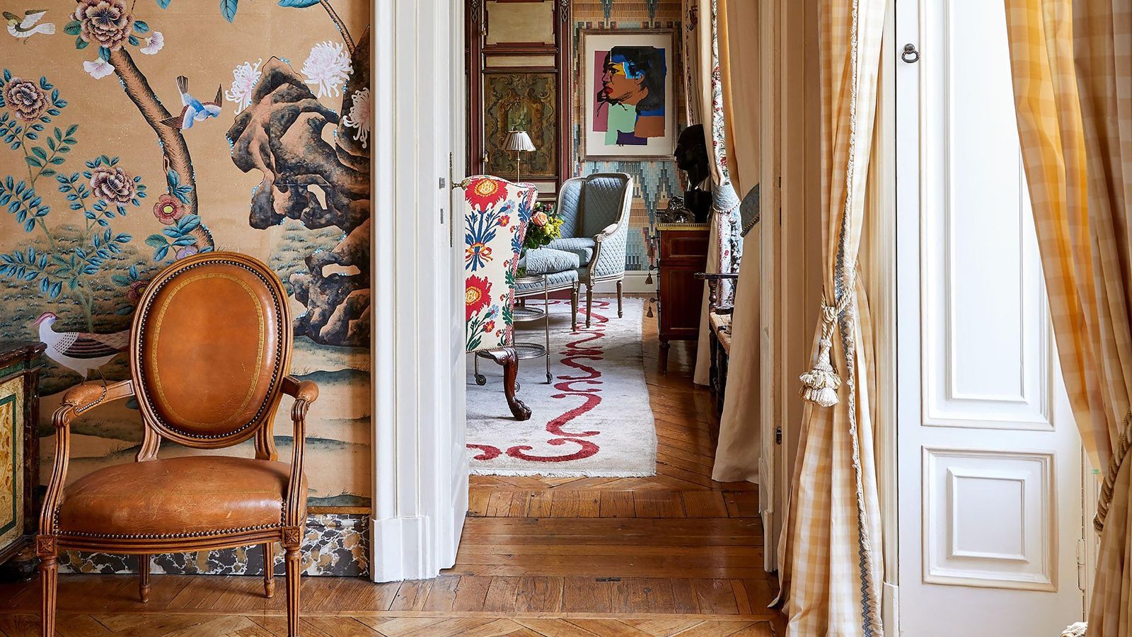Vibrant colorful hallway with leather mid century chair and oriental design wallpaper