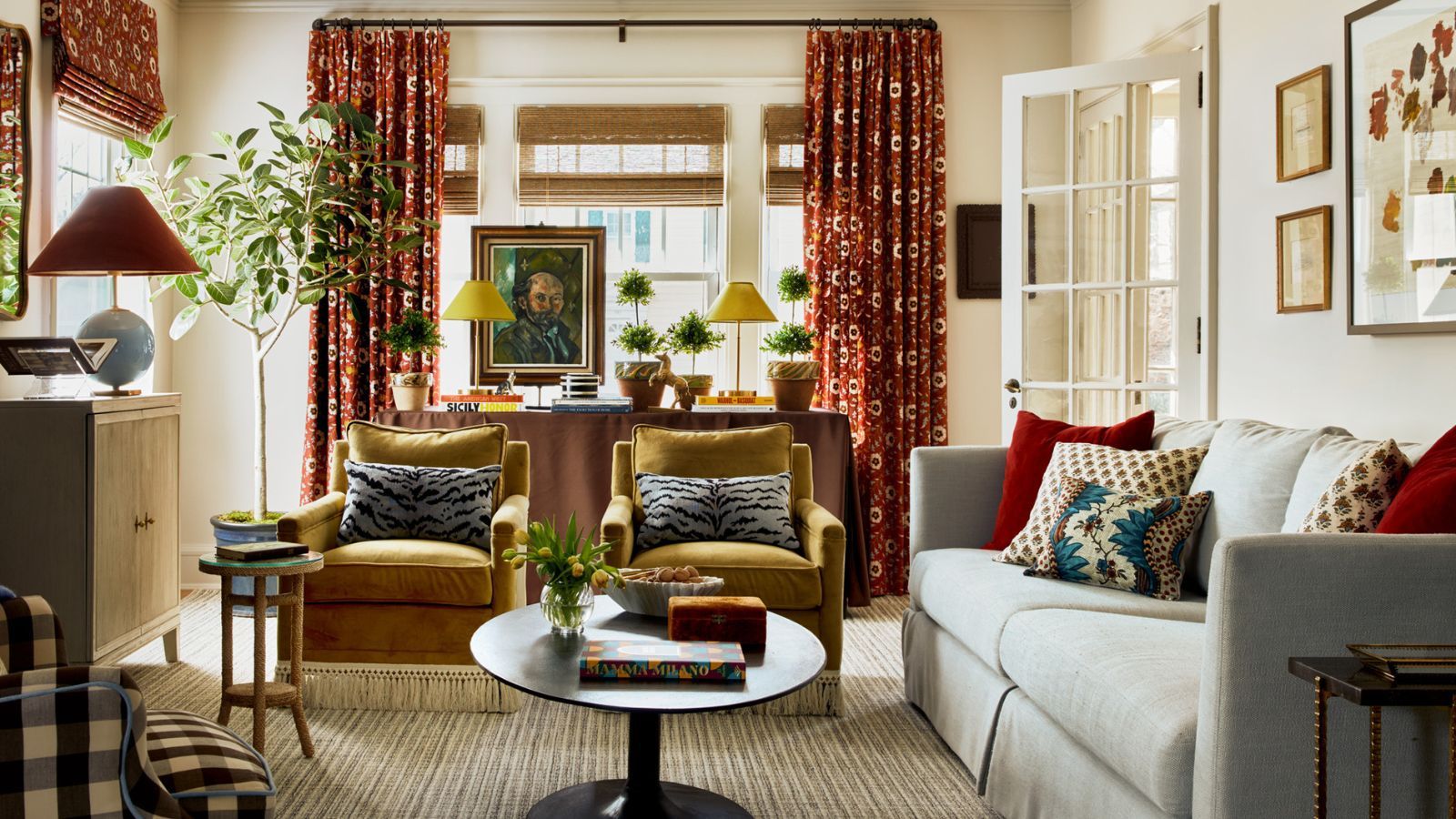 cozy living room decorated with fall colors with ochre velvet armchairs and burgundy burnt orange fabric accents