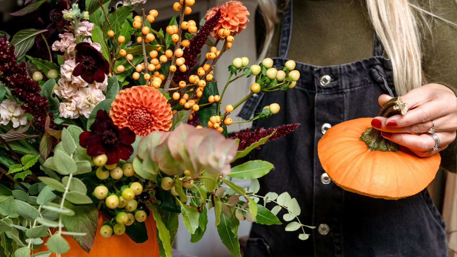 Floral design in pumpkin with orange dahlias, chocolate cosmos, eucalyptus and cream hypericum