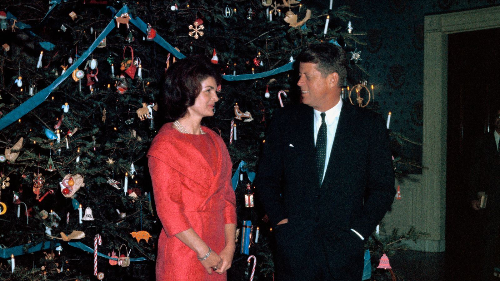 President John F. Kennedy with wife posed before the White House Christmas tree