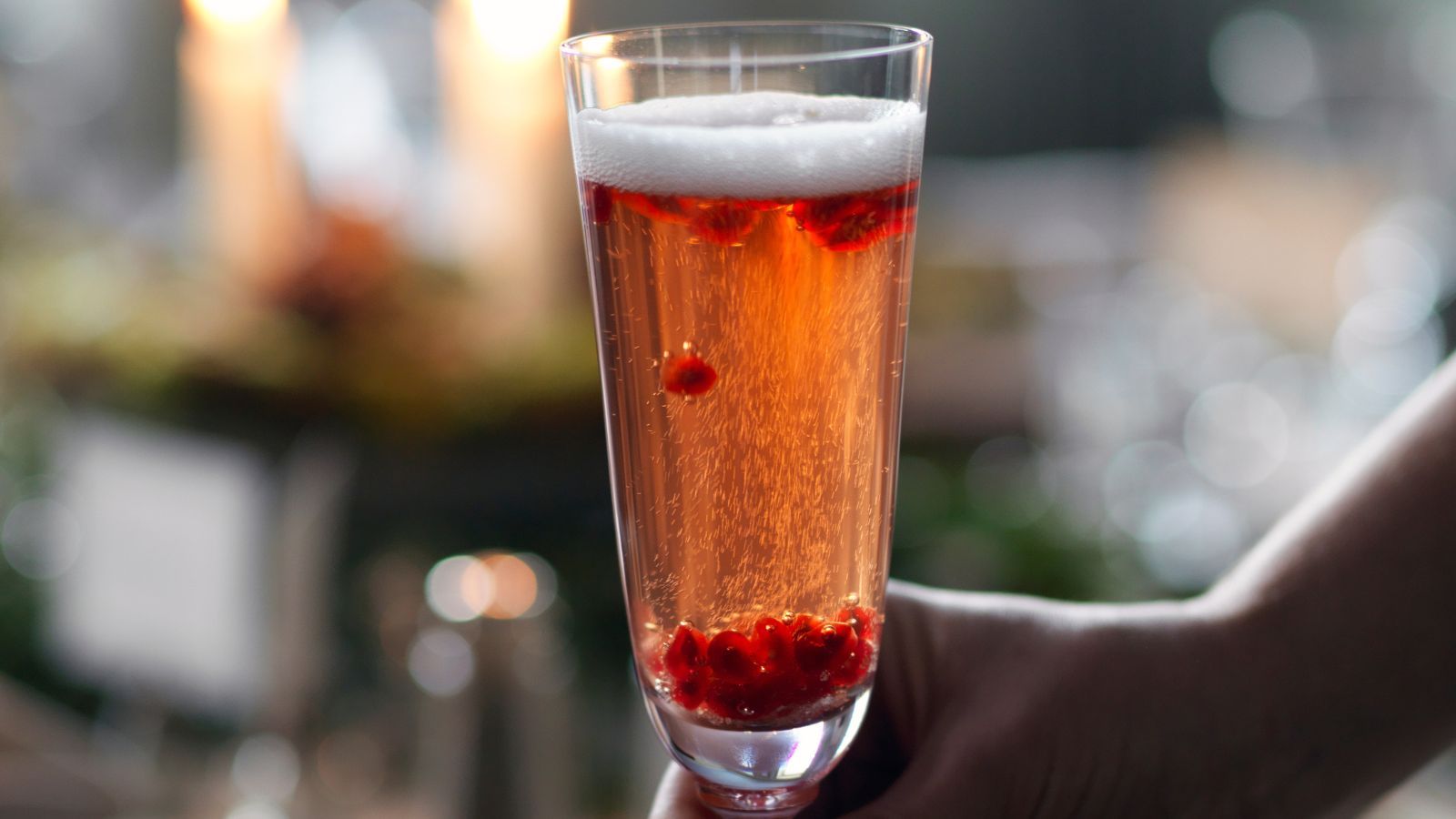 Christmas cocktail in a flute with pomegranates