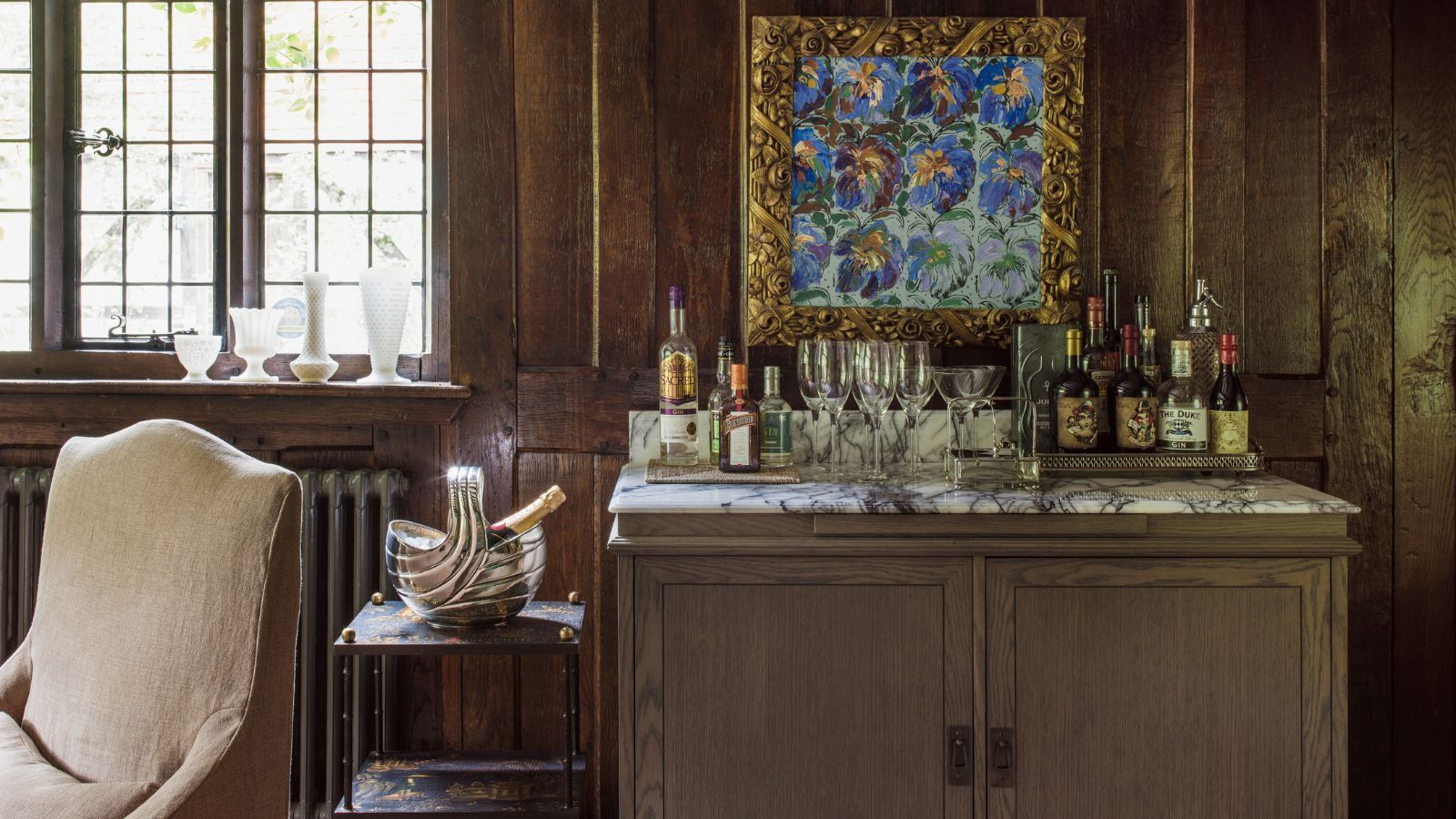 Home bar with marble counter and wood-panelled walls