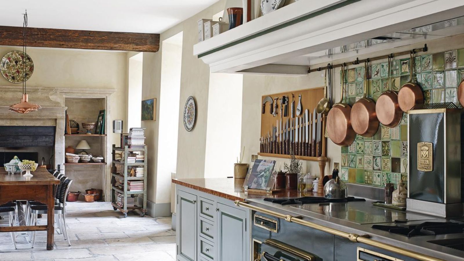 How We Test Cookware: A French country kitchen with hanging copper pans