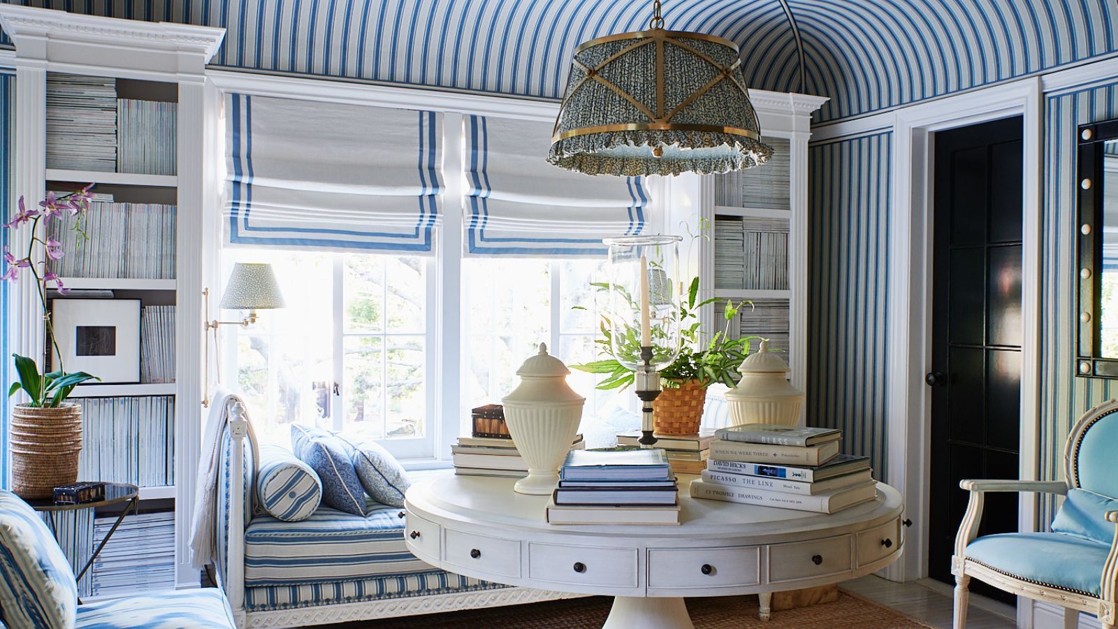 Blue and white striped living room with wallpaper, bench and chair matching and round white coffee table