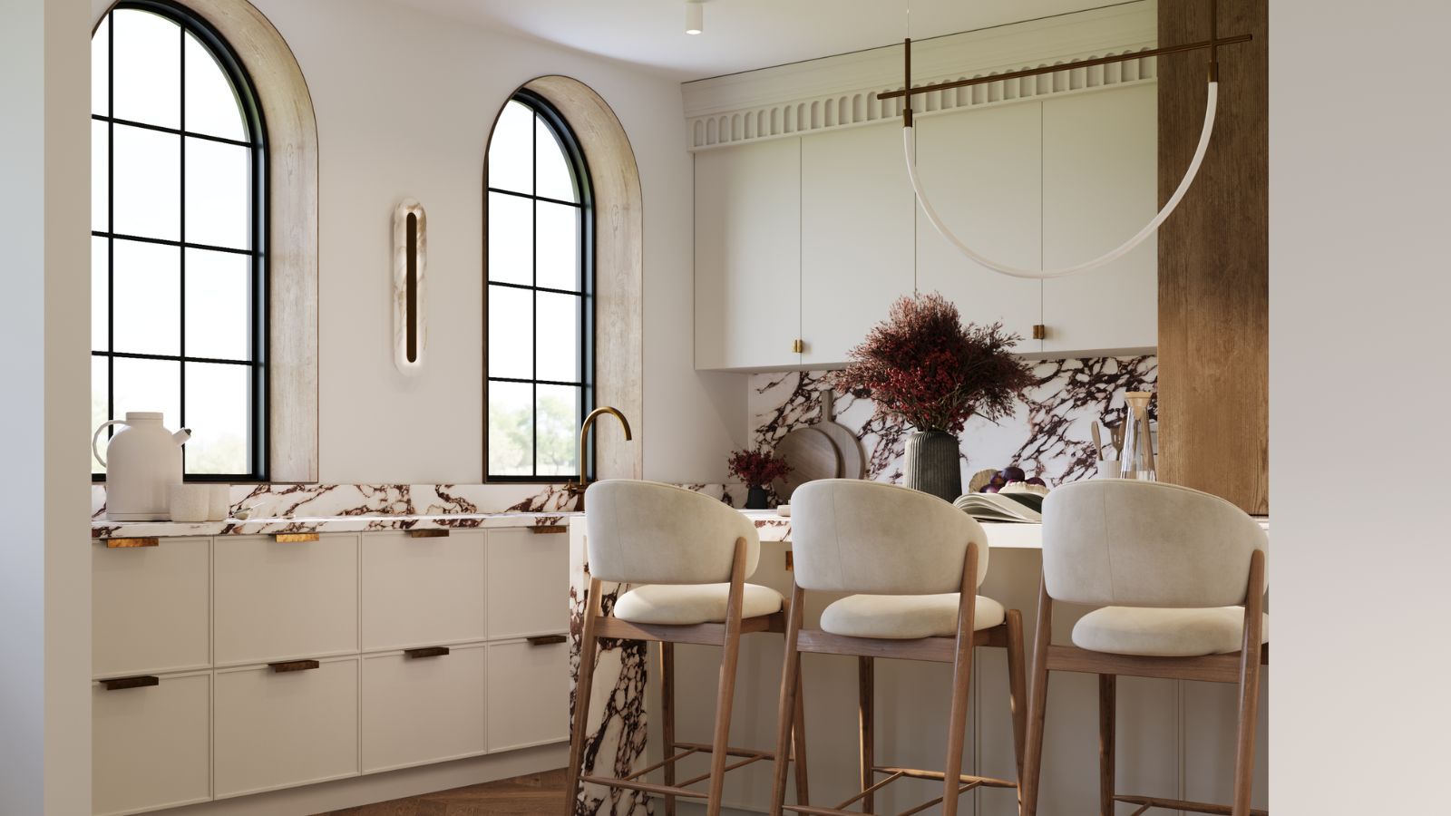 A warm white kitchen with marble countertops and bronze hardware