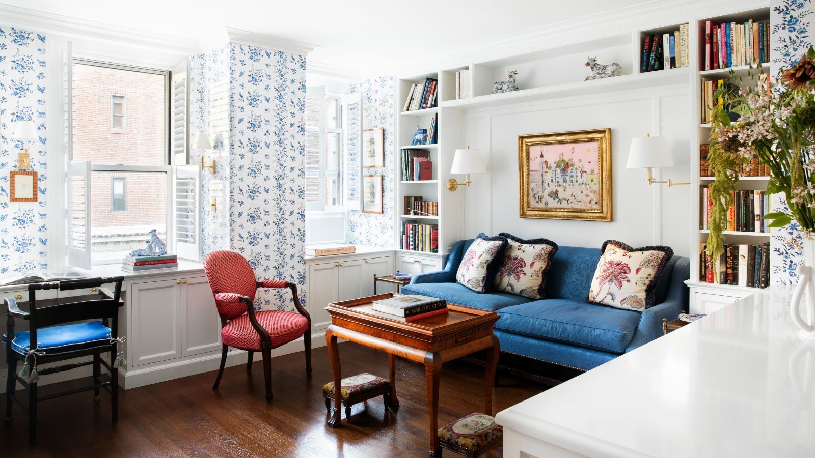 An open plan living room connected to a small kitchen