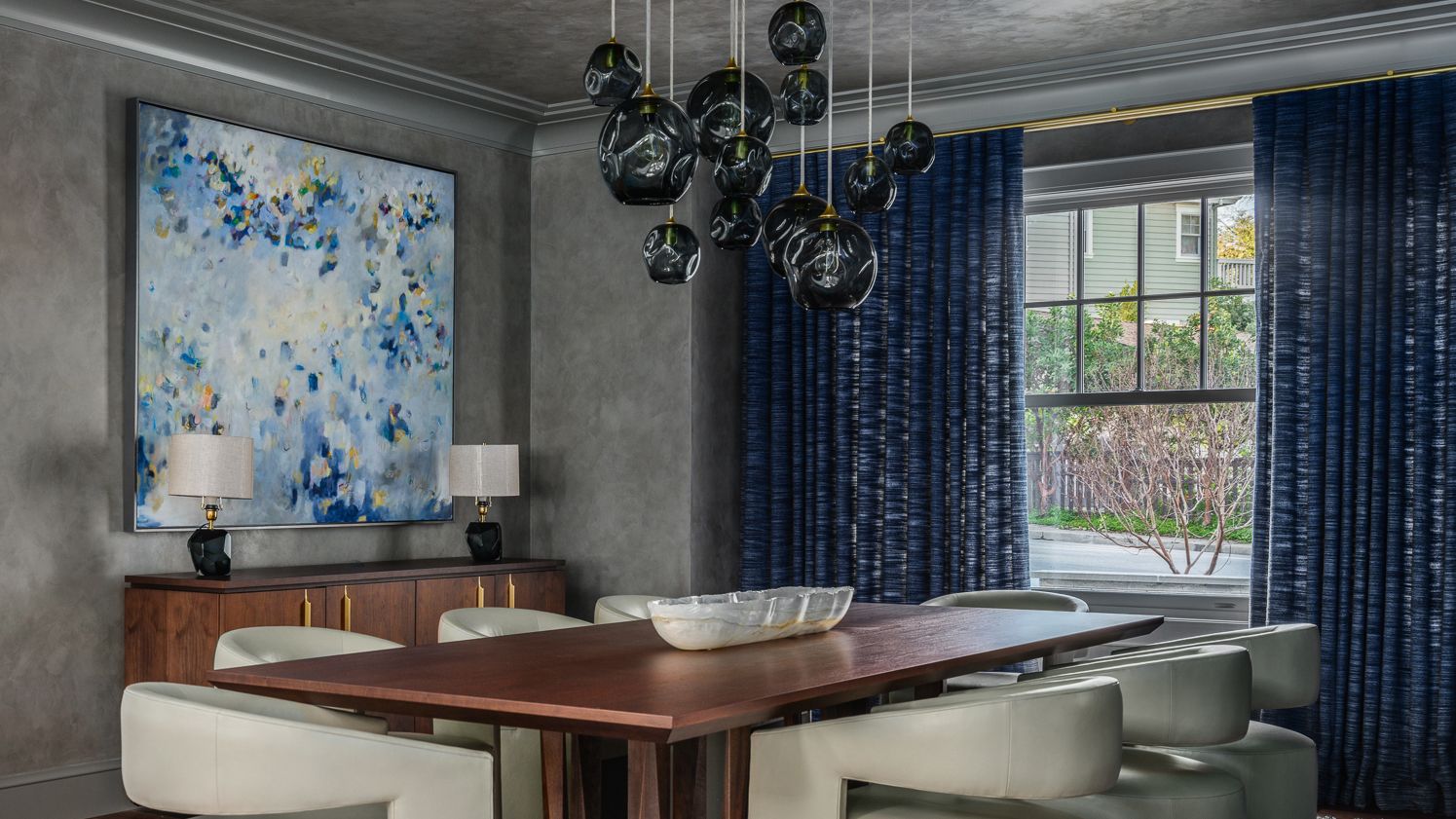 dining room with blue glass pendant light over the table