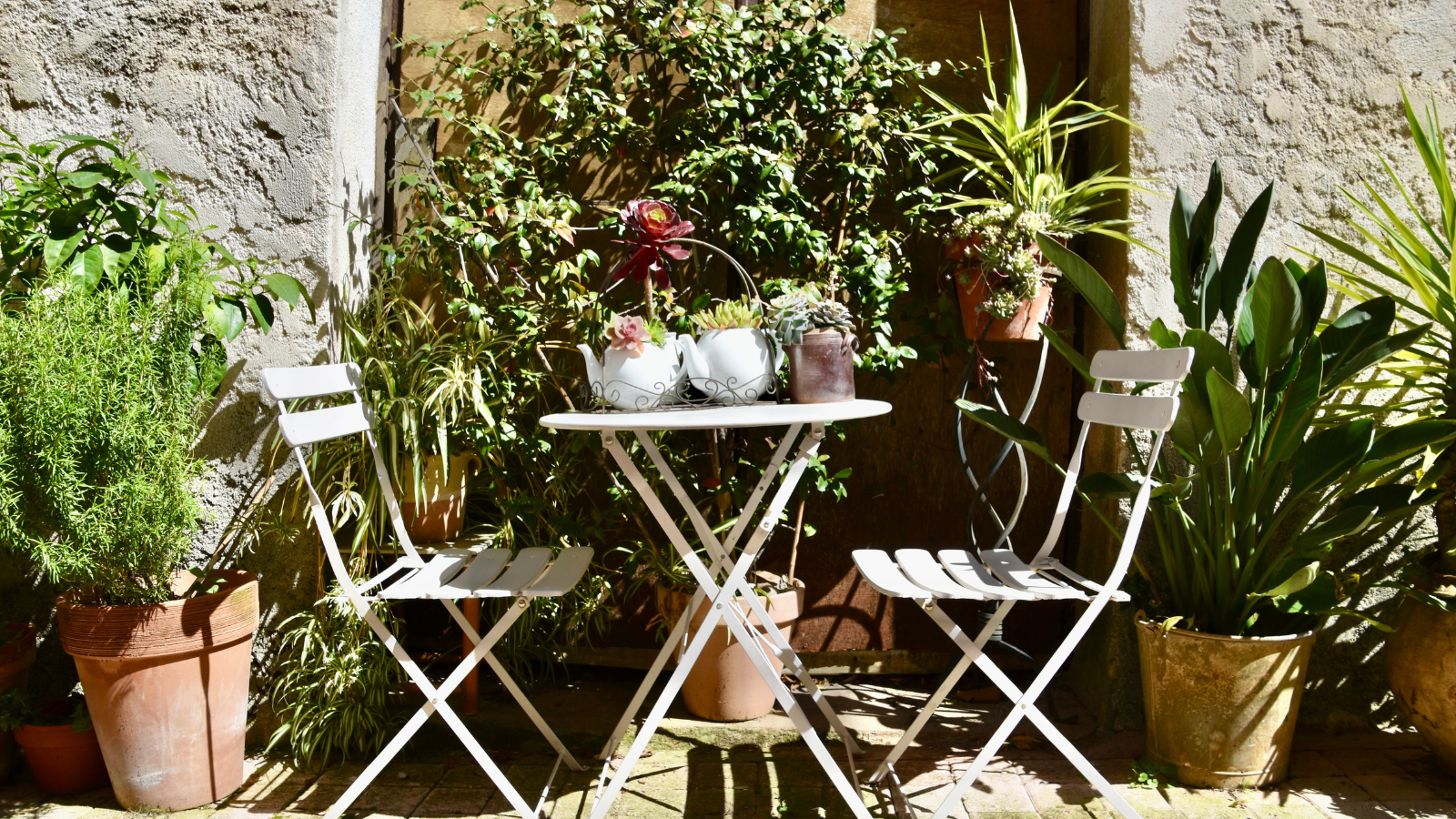 Provence patio seating area with terracotta plants