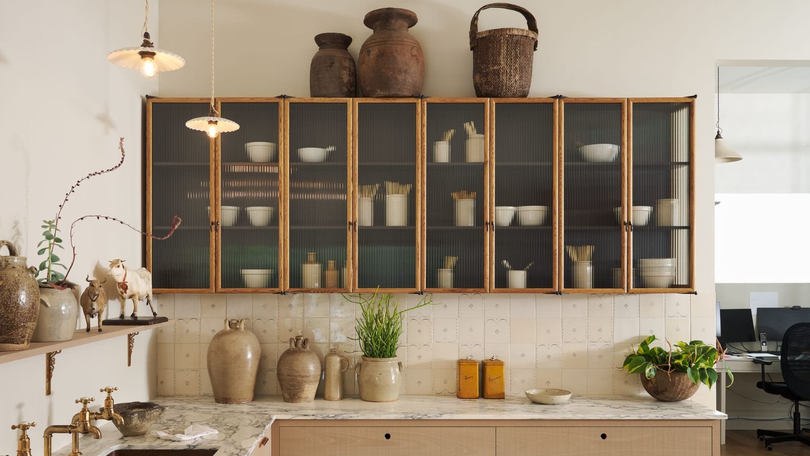 A warm wooden kitchen with a delft tiled splashback