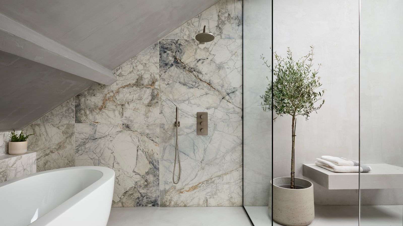 A modern bathroom with a large marble-walled wet room complete with a shower and free-standing tub.