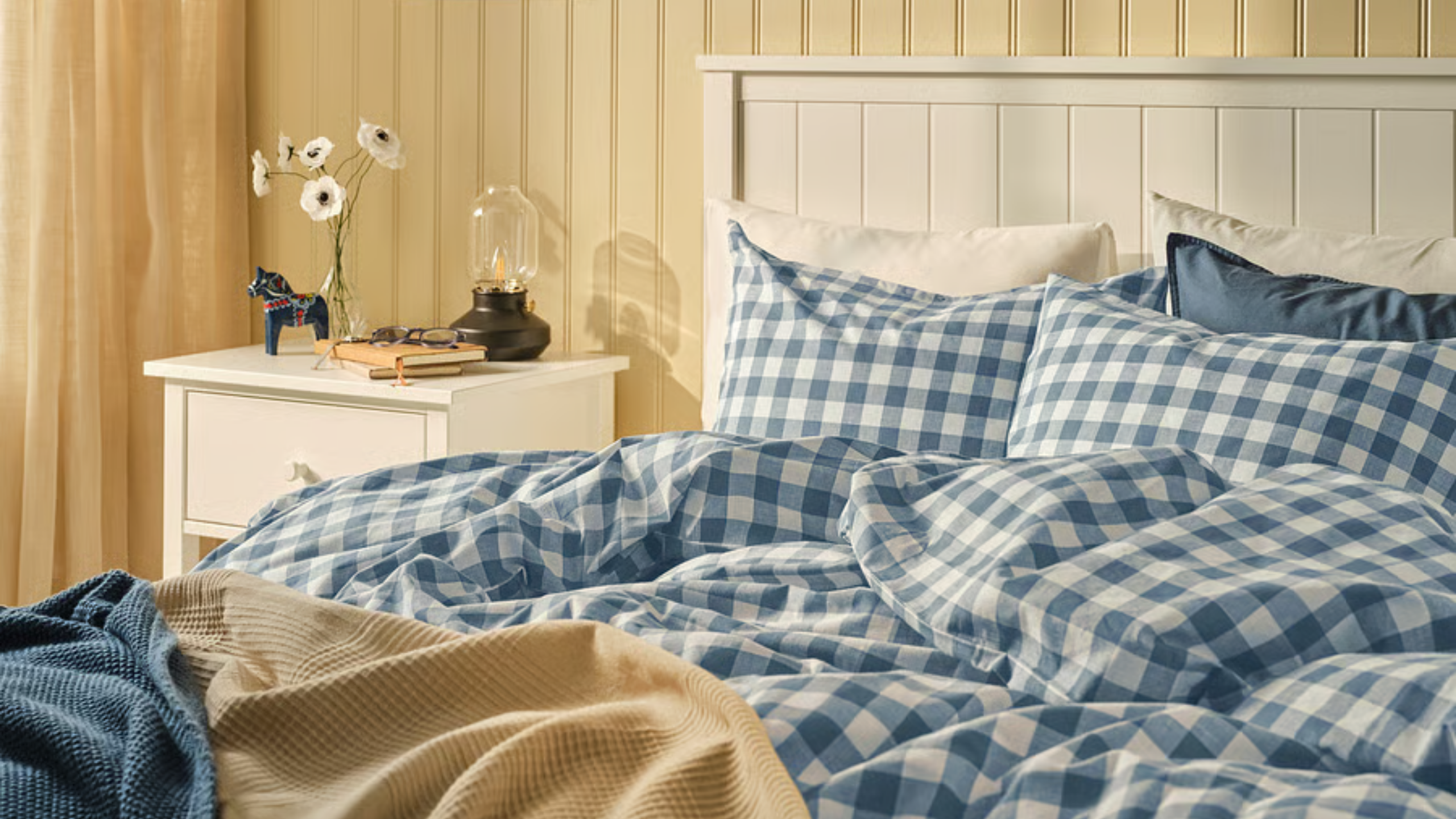 gingham bedding on a bed in a room with yellow paint