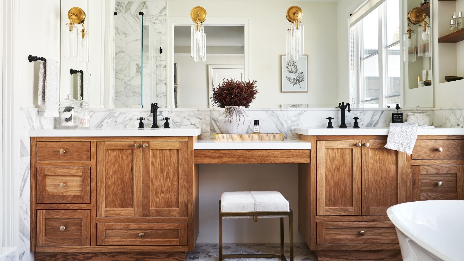 A large bathroom with white walls and a double wooden bathroom vanity