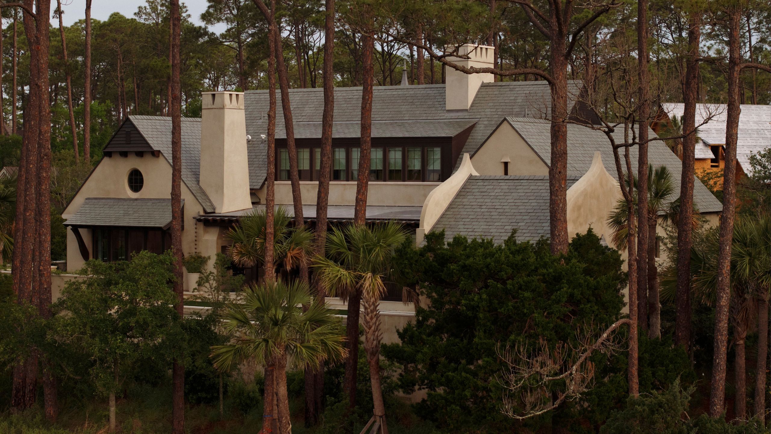 ein riesiges Haus mit Steinarchitektur und Schornsteinen, umgeben von Bäumen auf der Insel Kiawah