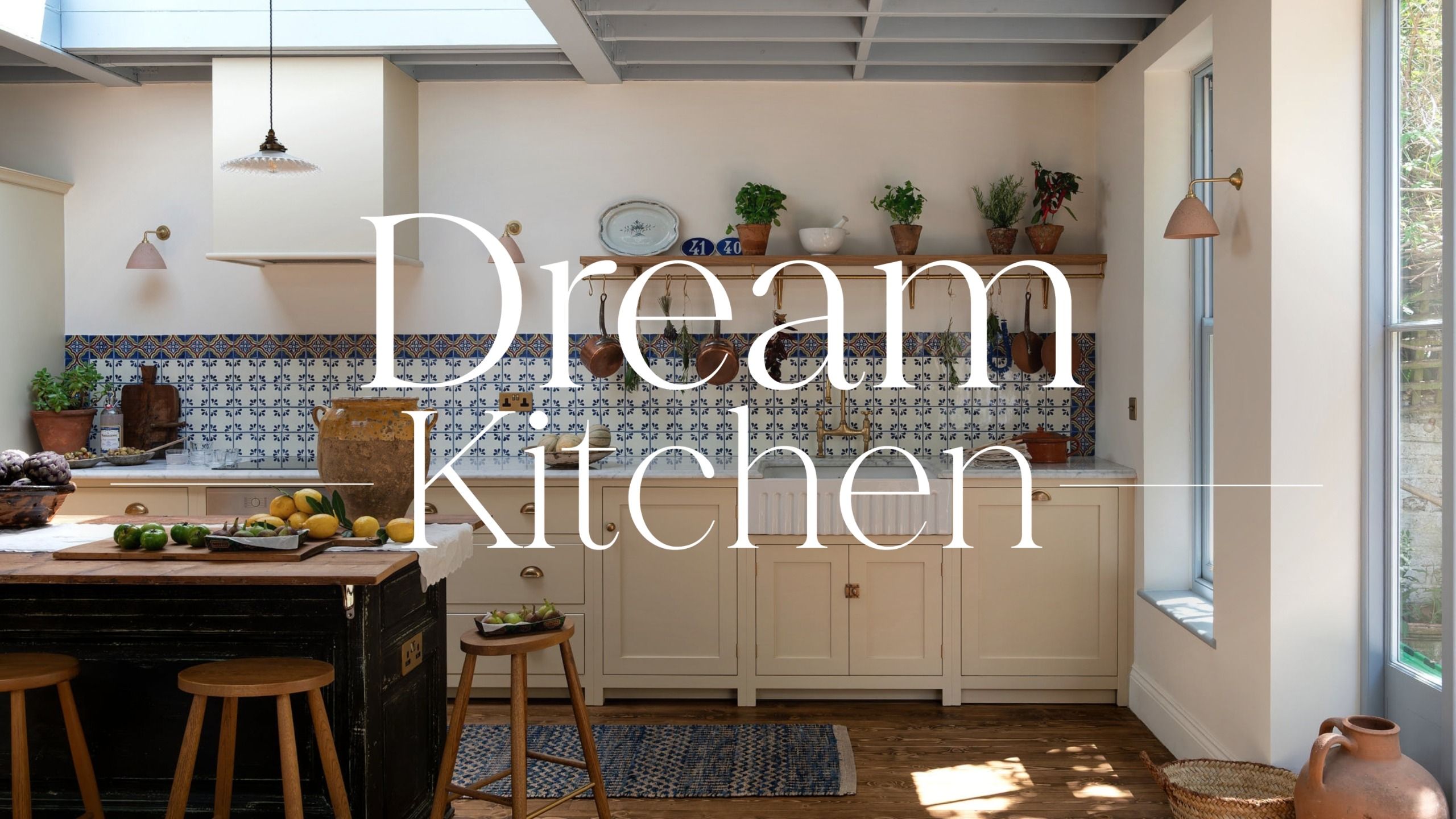 A large kitchen with white walls, yellow cabinets, and a blue and white patterned backsplash with a 'dream kitchen' overlay