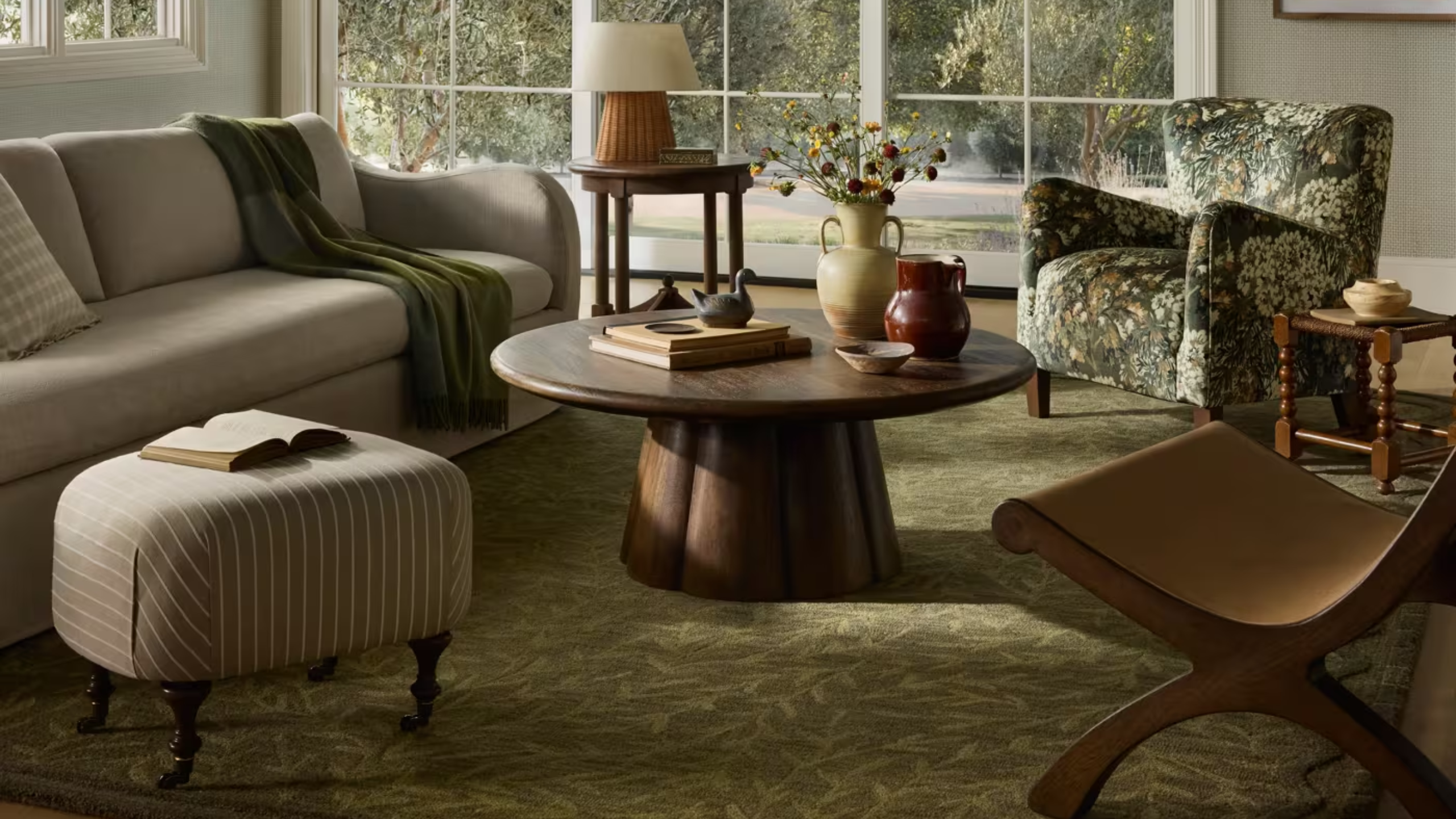 a cozy green living room with dark wood furniture
