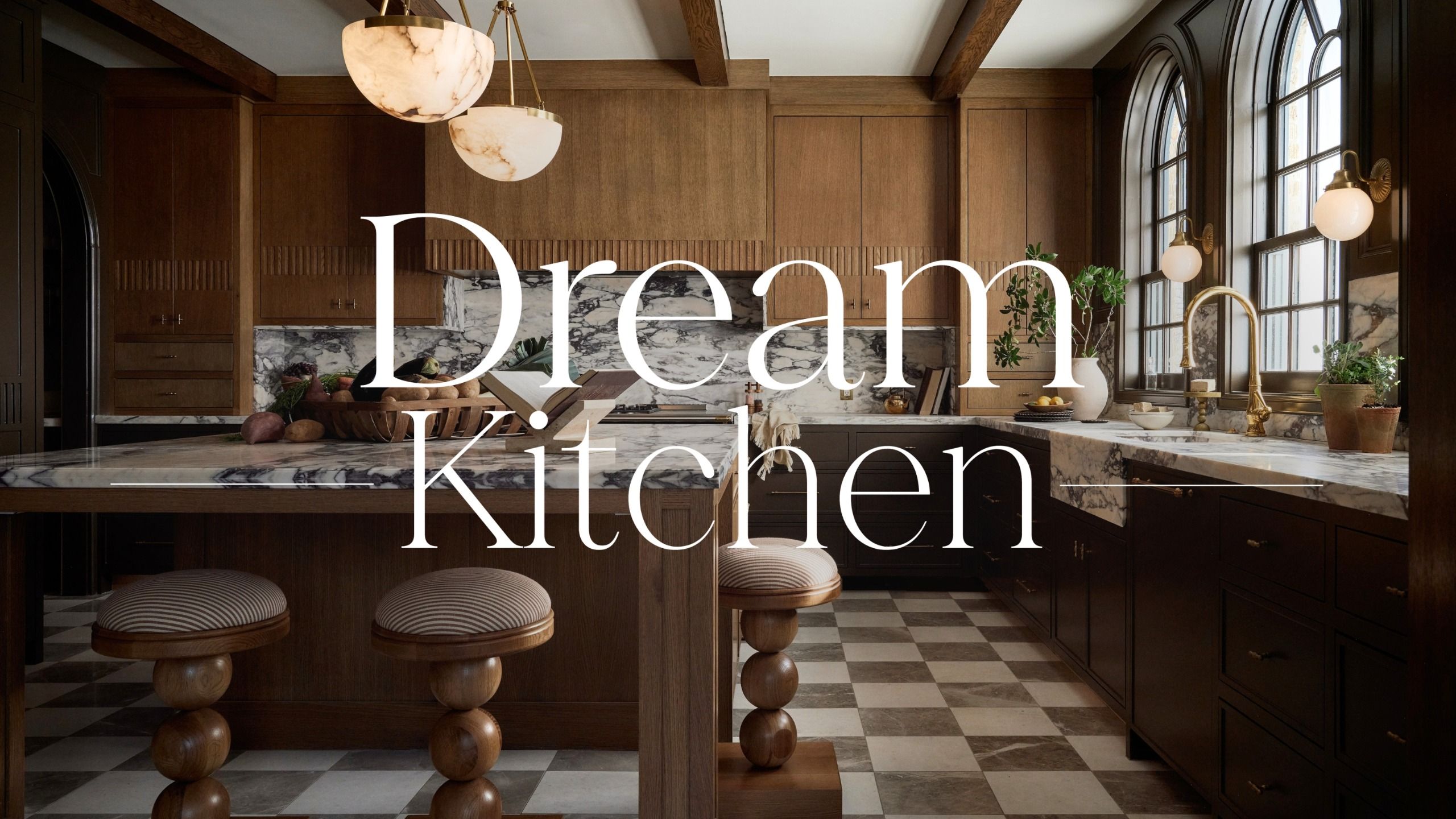 A kitchen with white oak cabinets and island with marble countertops and a checkerboard floor