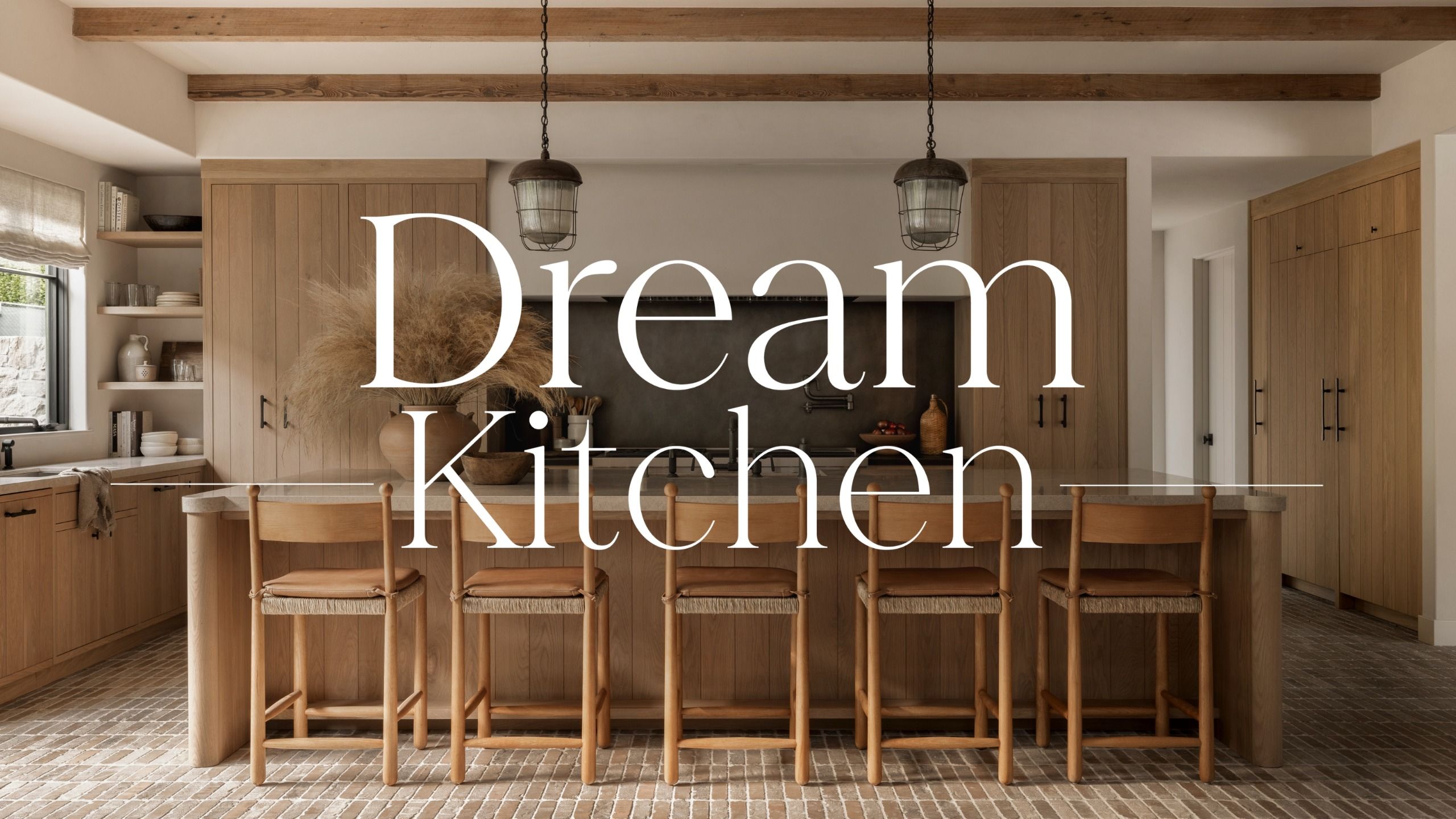 A warm wooden kitchen with light terracotta brick floors and marble countertops with a 'Dream Kitchen' text overlay